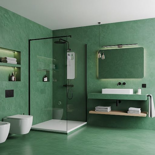 Baño moderno con paredes verdes, ducha con mampara, lavabo y estantería.